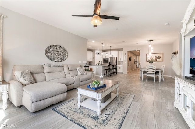 living room with sink and ceiling fan