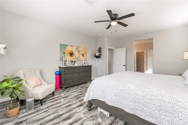 bedroom with light hardwood / wood-style flooring and ceiling fan