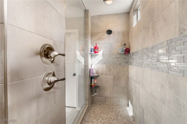 bathroom with tiled shower