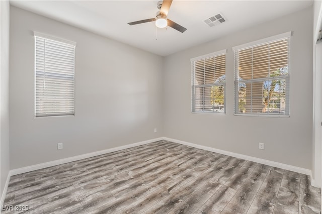 spare room with ceiling fan and hardwood / wood-style floors