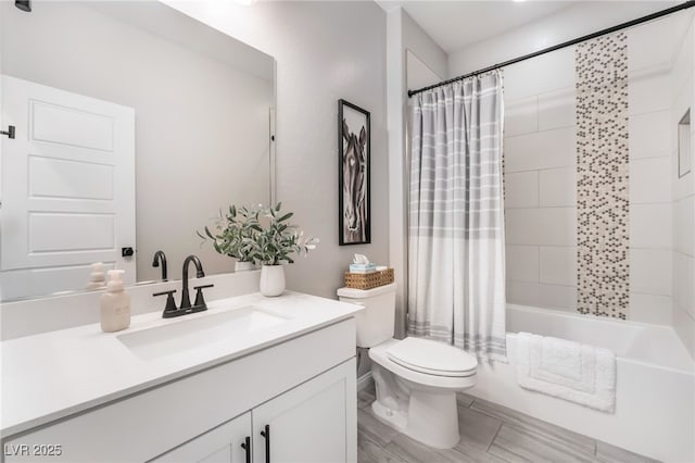 full bathroom with shower / bathtub combination with curtain, vanity, and toilet