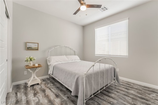 bedroom with dark wood-type flooring and ceiling fan