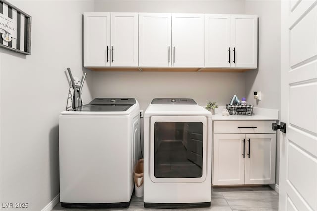 laundry room with cabinets and washing machine and dryer