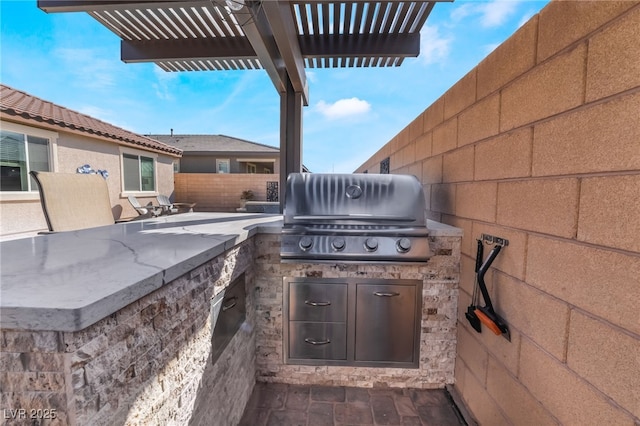 view of patio / terrace featuring a pergola, grilling area, and an outdoor kitchen