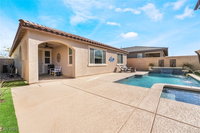 rear view of property with a patio, pool water feature, ceiling fan, a fenced in pool, and central AC