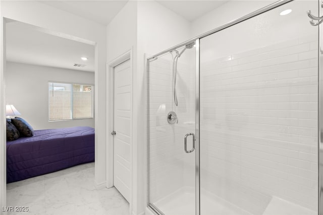 bathroom with a shower with door