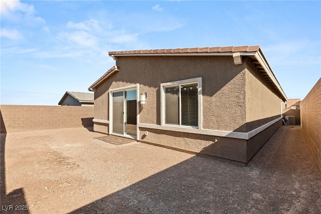 back of house featuring a patio area and central air condition unit