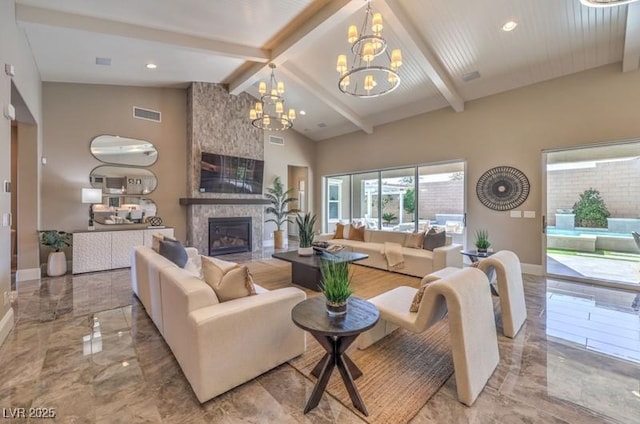 living area featuring marble finish floor, baseboards, visible vents, and a large fireplace