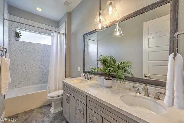 bathroom with double vanity, visible vents, a sink, and shower / bath combo with shower curtain