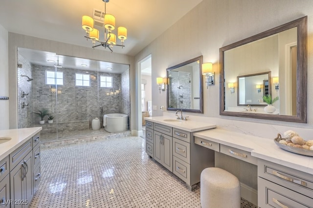 bathroom with a stall shower, visible vents, vanity, and an inviting chandelier