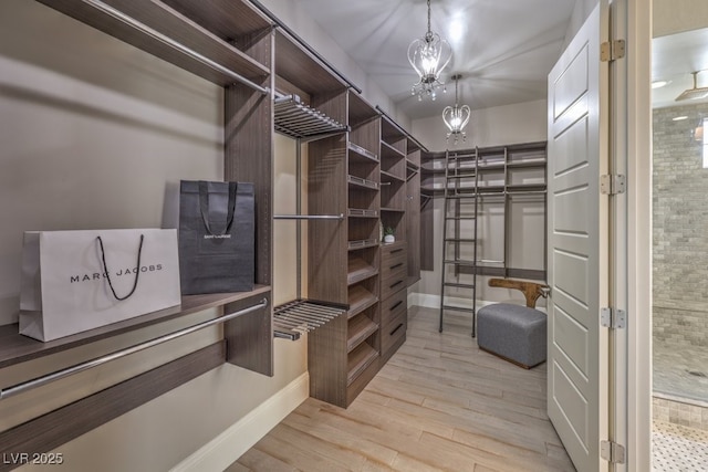 spacious closet featuring light wood-type flooring