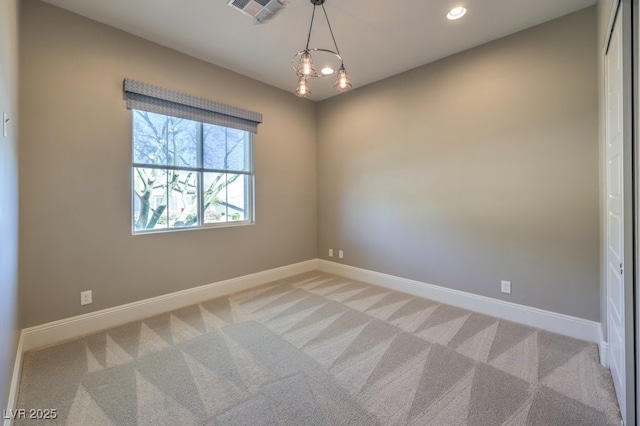 carpeted spare room featuring baseboards, visible vents, and recessed lighting