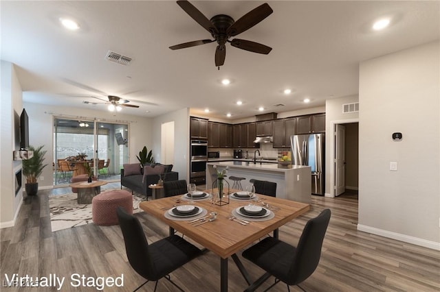 dining area with sink and wood-type flooring