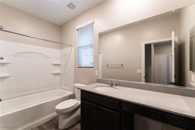 full bathroom featuring vanity, wood-type flooring, bathtub / shower combination, and toilet