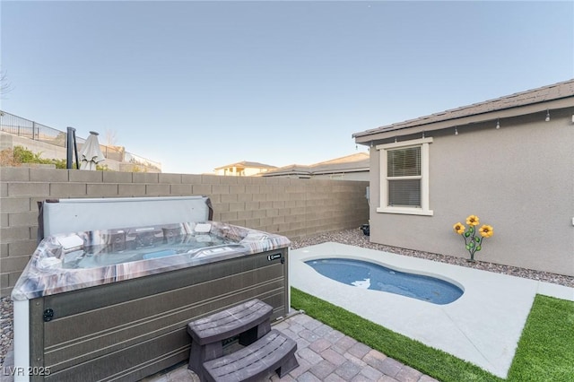 view of pool with a hot tub and a patio area