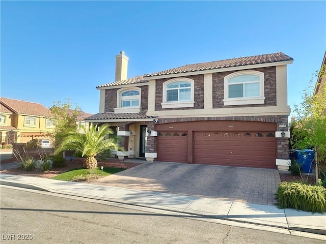 mediterranean / spanish home featuring a garage