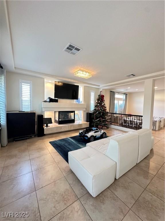 tiled living room with a healthy amount of sunlight