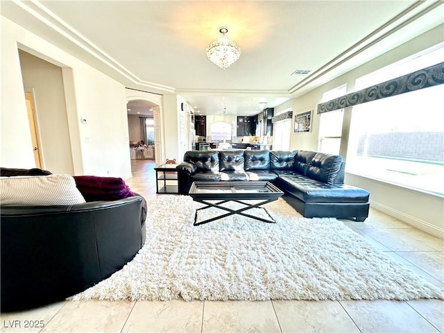 living room featuring a healthy amount of sunlight and a notable chandelier