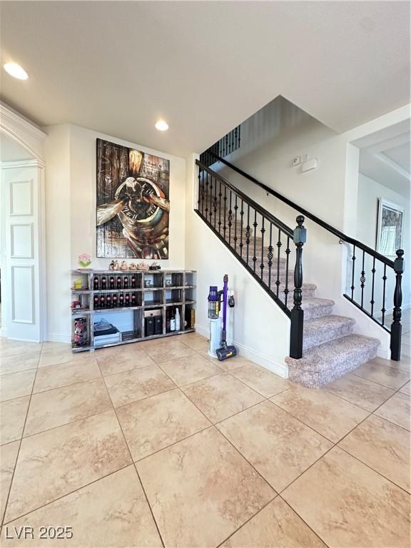 stairs featuring tile patterned floors