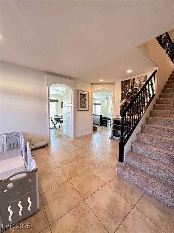 staircase featuring tile patterned flooring