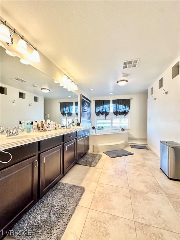 bathroom featuring tile patterned flooring and vanity