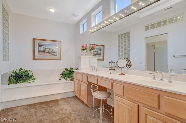 full bath featuring double vanity, visible vents, a bath, carpet flooring, and a sink