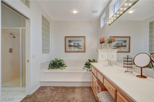 full bathroom featuring a stall shower, visible vents, vanity, and a bath