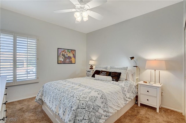 bedroom with light carpet, baseboards, and a ceiling fan