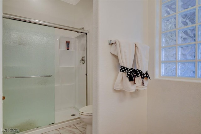 full bathroom with a shower stall and toilet