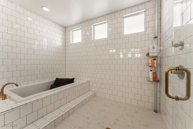 bathroom featuring tile walls, tile patterned floors, and a shower with door