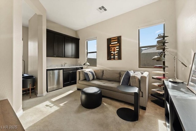 living room featuring light carpet and indoor wet bar