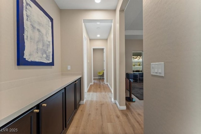 hallway with light hardwood / wood-style floors