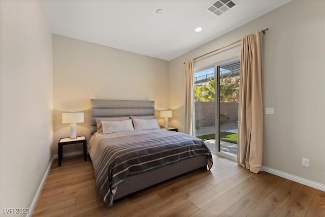 bedroom featuring access to exterior and light hardwood / wood-style floors