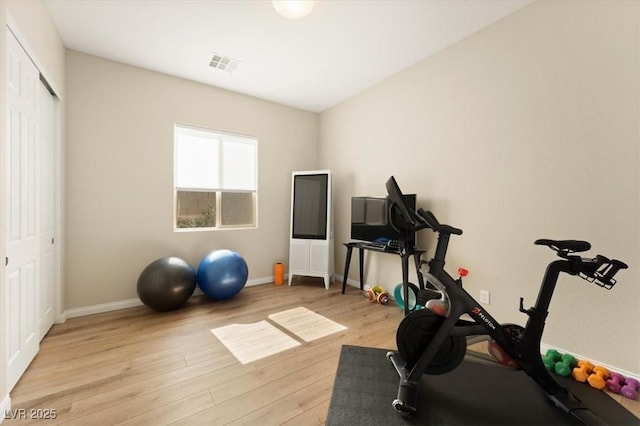 exercise room featuring light hardwood / wood-style floors