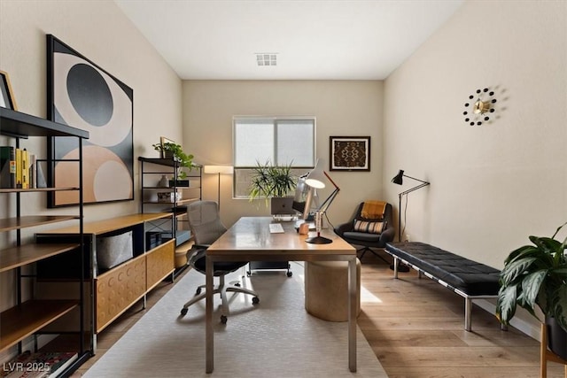 home office with hardwood / wood-style flooring