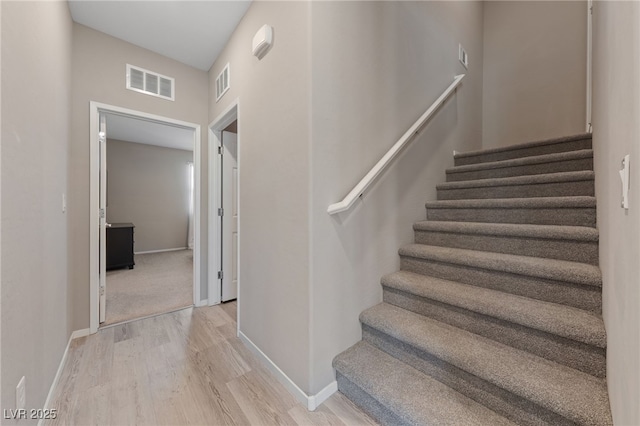 staircase with wood-type flooring