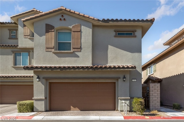 mediterranean / spanish-style house featuring a garage