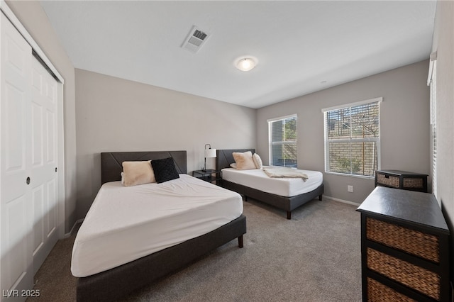 carpeted bedroom with a closet