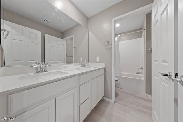 full bathroom with vanity, hardwood / wood-style flooring, shower / bath combination with curtain, and toilet