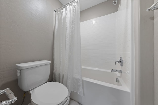 bathroom featuring toilet and shower / bath combo