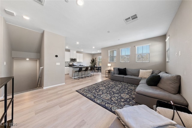 living room with light hardwood / wood-style floors