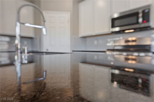 room details with dark stone counters and white cabinets