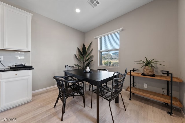 dining area with light hardwood / wood-style floors