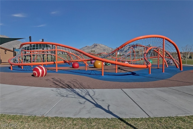 view of home's community featuring a playground and a mountain view