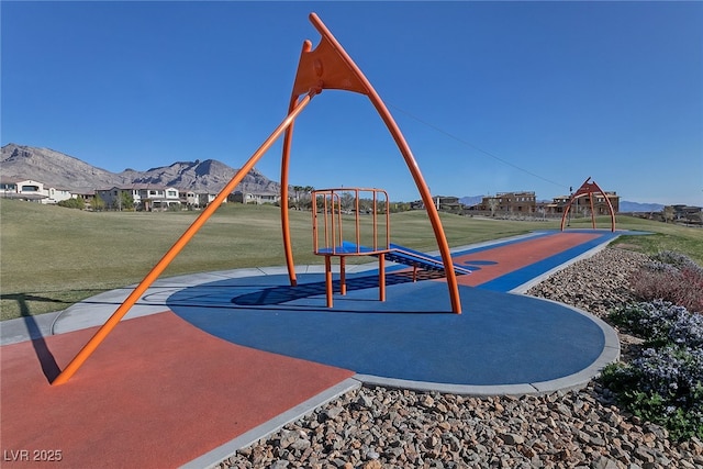 view of jungle gym with a yard and a mountain view