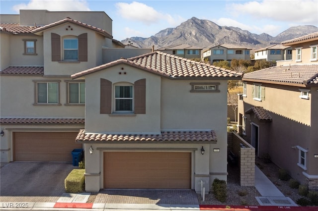 mediterranean / spanish-style home featuring a garage and a mountain view