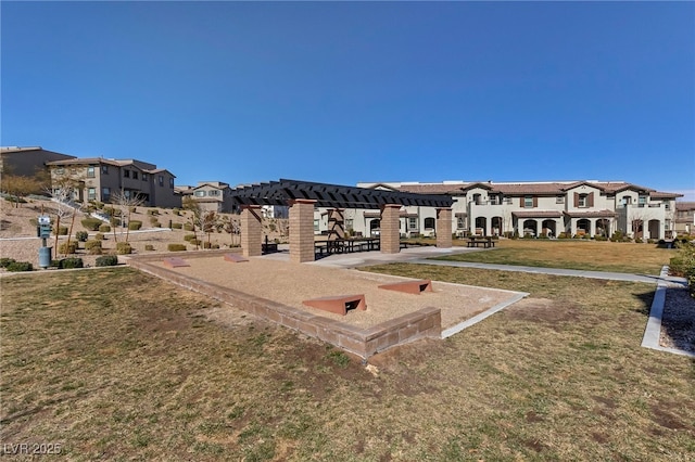 view of property's community featuring a yard and a pergola