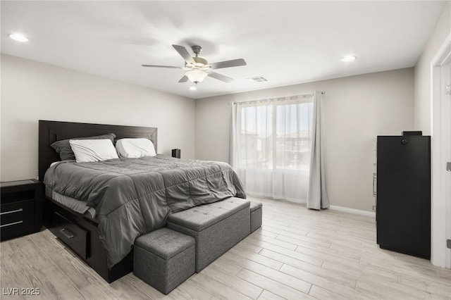 bedroom with light hardwood / wood-style flooring and ceiling fan