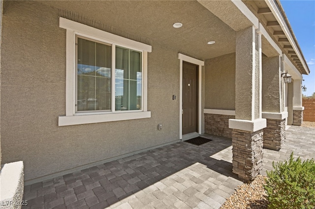 property entrance featuring a patio area