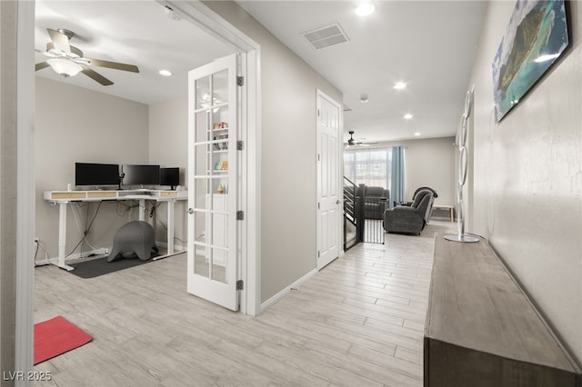 hall featuring french doors and light hardwood / wood-style floors